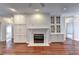 Inviting living room featuring hardwood floors, a fireplace, and large built-in cabinets at 2324 Blackberry Ct, Snellville, GA 30078