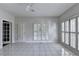Bright room with white tile flooring, large windows with white shutters, and a ceiling fan at 2324 Blackberry Ct, Snellville, GA 30078