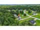 An aerial view of a charming two-story home nestled in a lush, green, tree-filled neighborhood with well-maintained lawns at 30 Creek Bottom Dr, Covington, GA 30014