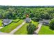 Aerial view of a well-maintained home with a spacious yard, mature trees, and a long driveway at 30 Creek Bottom Dr, Covington, GA 30014