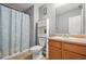 View of the bathroom featuring a toilet, sink with storage, mirror and shower with curtain at 30 Creek Bottom Dr, Covington, GA 30014
