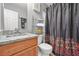 Bathroom vanity with granite counters, and shower with decorative curtain at 30 Creek Bottom Dr, Covington, GA 30014