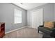 Neutral bedroom featuring carpet, gray walls, a double door closet and a large window for plenty of light at 30 Creek Bottom Dr, Covington, GA 30014
