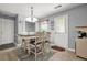 Bright dining area with a modern table, adjacent to a door leading outside at 30 Creek Bottom Dr, Covington, GA 30014