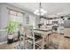 Bright dining area with a modern table, adjacent to the kitchen at 30 Creek Bottom Dr, Covington, GA 30014