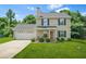 Charming two-story home with a well-manicured lawn and attached garage at 30 Creek Bottom Dr, Covington, GA 30014