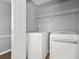 This laundry room features a washer, dryer and wire rack for storage at 30 Creek Bottom Dr, Covington, GA 30014