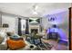 Comfortable living room area with a fireplace, neutral tones, and a ceiling fan at 30 Creek Bottom Dr, Covington, GA 30014