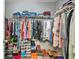 Walk-in closet with shelving and hanging rods filled with clothes and shoes at 30 Creek Bottom Dr, Covington, GA 30014