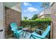 Outdoor balcony with two blue chairs, a small table and greenery at 3301 Henderson Mill Rd # Aa3, Atlanta, GA 30341
