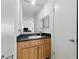 Bathroom features a vanity with dark countertop and wood cabinets at 3301 Henderson Mill Rd # Aa3, Atlanta, GA 30341