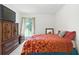 Cozy bedroom features a large window, dresser with television, and a bed with patterned bedding at 3301 Henderson Mill Rd # Aa3, Atlanta, GA 30341