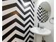 Modern half bathroom with eye-catching black and white chevron patterned wall and pedestal sink at 3301 Henderson Mill Rd # Aa3, Atlanta, GA 30341