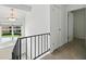 Upstairs hallway featuring a window, railing, storage closet, and carpet flooring at 3301 Henderson Mill Rd # Aa3, Atlanta, GA 30341