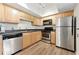 Functional kitchen with stainless steel appliances, wood cabinets, and modern countertops at 3301 Henderson Mill Rd # Aa3, Atlanta, GA 30341