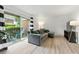 Cozy living room featuring a sliding door to the patio, and an inviting grey sectional sofa at 3301 Henderson Mill Rd # Aa3, Atlanta, GA 30341