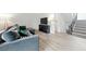 Inviting living room featuring light wood floors, a comfortable gray couch and staircase access at 3301 Henderson Mill Rd # Aa3, Atlanta, GA 30341