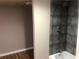 Remodeled bathroom features a shower with black tile surround, fresh paint, and new floor at 4744 Chickasaw Se Way, Acworth, GA 30102