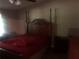 Bedroom featuring a vintage-style bed with red bedding and wood furniture at 4744 Chickasaw Se Way, Acworth, GA 30102