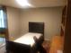 Bedroom with hardwood floors, a single bed, and matching shelves and desk at 4744 Chickasaw Se Way, Acworth, GA 30102
