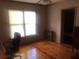 Bedroom with hardwood floors, window with blinds, and classic trim at 4744 Chickasaw Se Way, Acworth, GA 30102