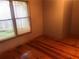 Bedroom featuring hardwood floors, neutral walls, a window with blinds, and a dark trim at 4744 Chickasaw Se Way, Acworth, GA 30102