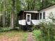 Charming home with a screened in porch and wooded lot sits far back from the road at 4744 Chickasaw Se Way, Acworth, GA 30102