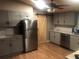 Renovated kitchen featuring stainless steel appliances, light gray cabinets, and granite countertops at 4744 Chickasaw Se Way, Acworth, GA 30102