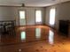 Large living room featuring gleaming hardwood floors, a fireplace, and bright natural light from the windows at 4744 Chickasaw Se Way, Acworth, GA 30102