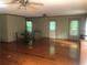 Spacious living room featuring hardwood floors, neutral walls, a ceiling fan, and lots of natural light at 4744 Chickasaw Se Way, Acworth, GA 30102