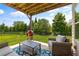 Relaxing back patio with outdoor seating, grill, and view of the manicured lawn and greenery at 508 Windy Ridge Ct, Canton, GA 30114
