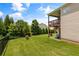 Well-maintained backyard with expansive lawn, mature trees, and a cozy patio for outdoor enjoyment at 508 Windy Ridge Ct, Canton, GA 30114