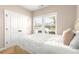 Bright bedroom featuring white bedding and a double door closet with outside view at 508 Windy Ridge Ct, Canton, GA 30114