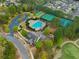 Aerial view of community pool, tennis courts, playground, and parking lot surrounded by lush landscaping at 508 Windy Ridge Ct, Canton, GA 30114
