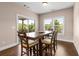 Dining room area with sliding glass door, wood-style flooring, and natural light at 508 Windy Ridge Ct, Canton, GA 30114