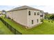 View of house showing the fenced backyard with large lawn, landscaping, patio, and grill at 508 Windy Ridge Ct, Canton, GA 30114