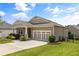 A single-story home with neutral siding, a two-car garage, and a well-maintained lawn, showcasing the property's exterior at 508 Windy Ridge Ct, Canton, GA 30114