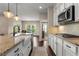 Beautiful kitchen featuring white cabinetry, stainless steel appliances, granite countertops, and a stylish tile backsplash at 508 Windy Ridge Ct, Canton, GA 30114