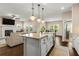 Bright, open-concept kitchen with large center island, seating, pendant lights, and access to dining and living areas at 508 Windy Ridge Ct, Canton, GA 30114