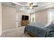 Main bedroom shows natural light, TV, neutral paint, ceiling fan, carpet and curtains at 508 Windy Ridge Ct, Canton, GA 30114