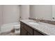 Bathroom features a granite countertop, dark wood cabinets, and tub with tiled shower at 1117 Cordia Ave, Atlanta, GA 30318