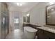 Luxurious bathroom with a soaking tub, granite countertops, and a glass-enclosed shower at 1117 Cordia Ave, Atlanta, GA 30318