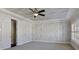 Bright, neutral bedroom features a ceiling fan, shutters, and a closet at 1117 Cordia Ave, Atlanta, GA 30318