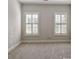 Well-lit bedroom with neutral carpeting and two shuttered windows providing natural light at 1117 Cordia Ave, Atlanta, GA 30318