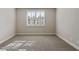 Neutral bedroom with a window allowing for ample natural light and newly installed carpet at 1117 Cordia Ave, Atlanta, GA 30318