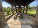 Outdoor covered patio with stone fireplace, picnic table and bench seating at 1117 Cordia Ave, Atlanta, GA 30318