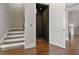 Convenient home elevator and stairway with elegant wood floors providing easy access between levels at 1117 Cordia Ave, Atlanta, GA 30318