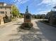 Welcoming gated entrance to the Enclave on Collier, featuring a brick and stone sign and lush landscaping at 1117 Cordia Ave, Atlanta, GA 30318