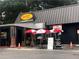 Exterior view of Big Easy Louisiana Eats Grille featuring red and white umbrellas and signage at 1117 Cordia Ave, Atlanta, GA 30318