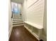Hallway and staircase leading to upper level includes a built-in mud bench with storage at 1117 Cordia Ave, Atlanta, GA 30318